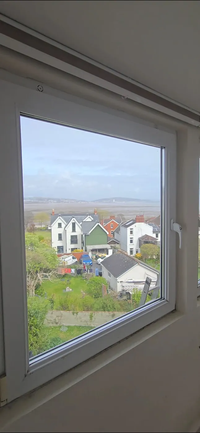 A window fitted with the Active Trickle Vent in a bedroom overlooking Swansea Bay